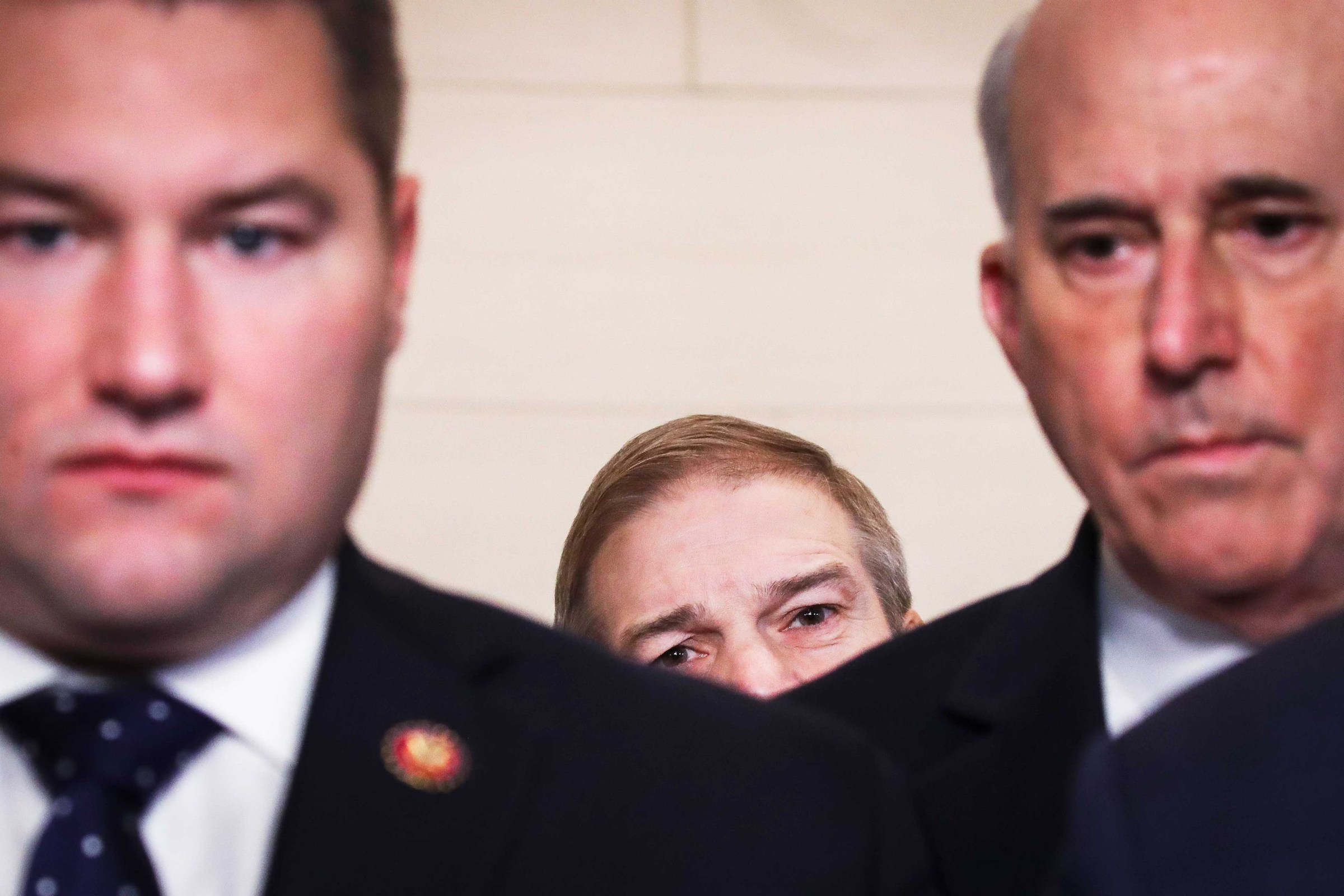 Reps. Guy Reschenthaler (R-PA), Jim Jordan (R-OH), and Louie Gohmert (R-TX) look on as fellow Republicans speak to the press after the House Judiciary Committee approved articles of impeachment against President Trump on December 13, 2019.