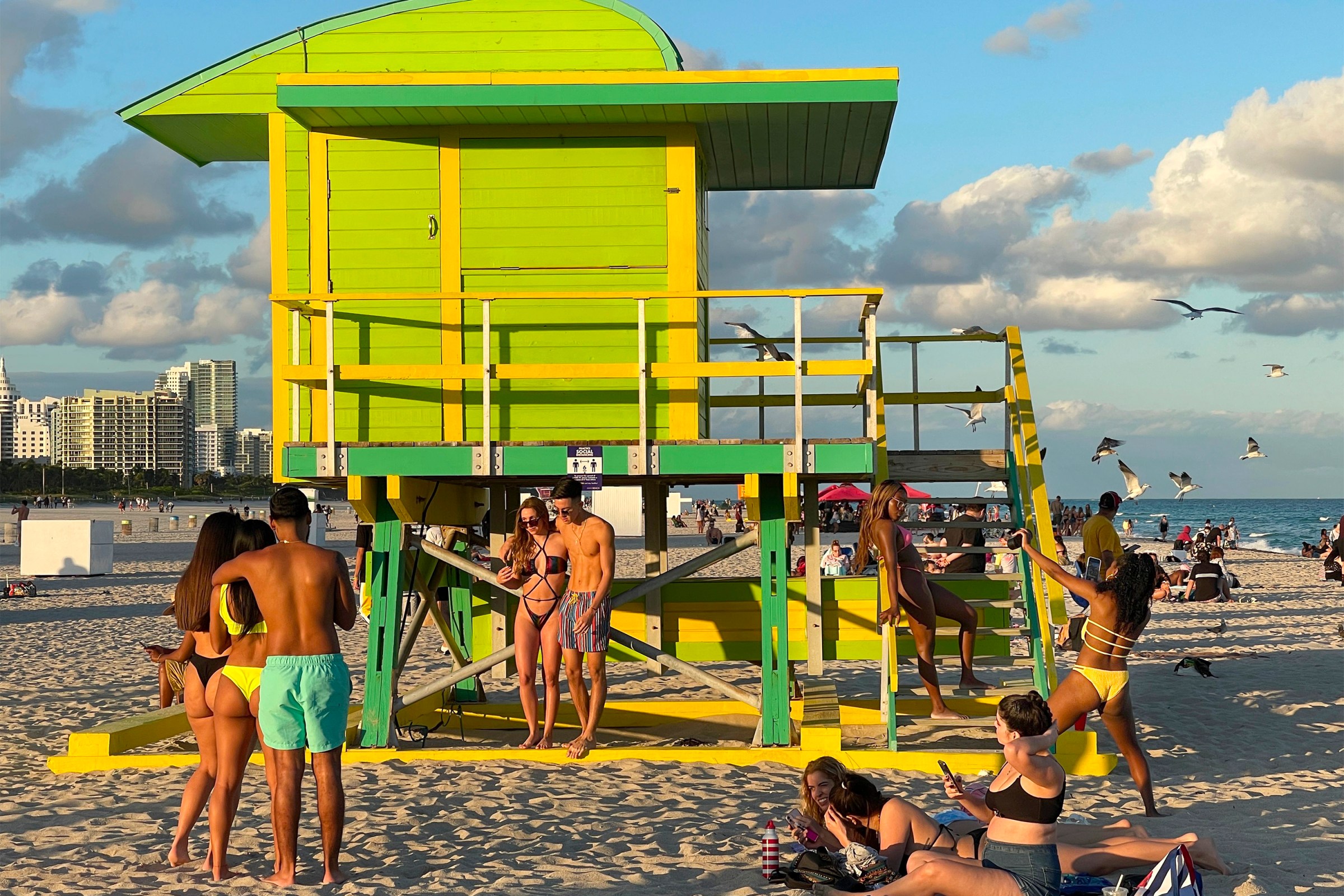 Beachgoers take selfies in South Beach, Florida, on December 19, 2020.